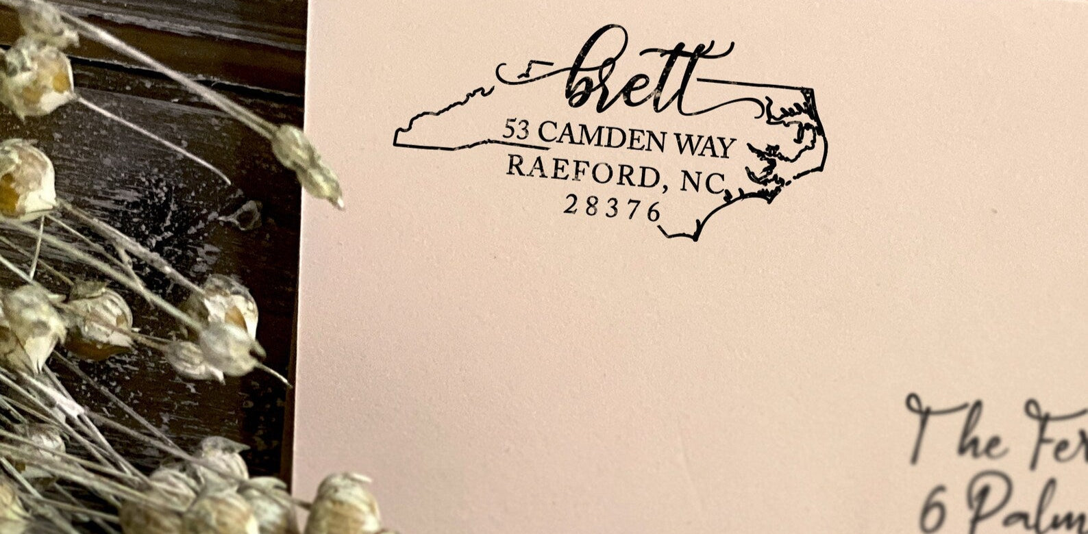 Custom North Carolina state outline return address stamp in black for Brett, Raeford NC