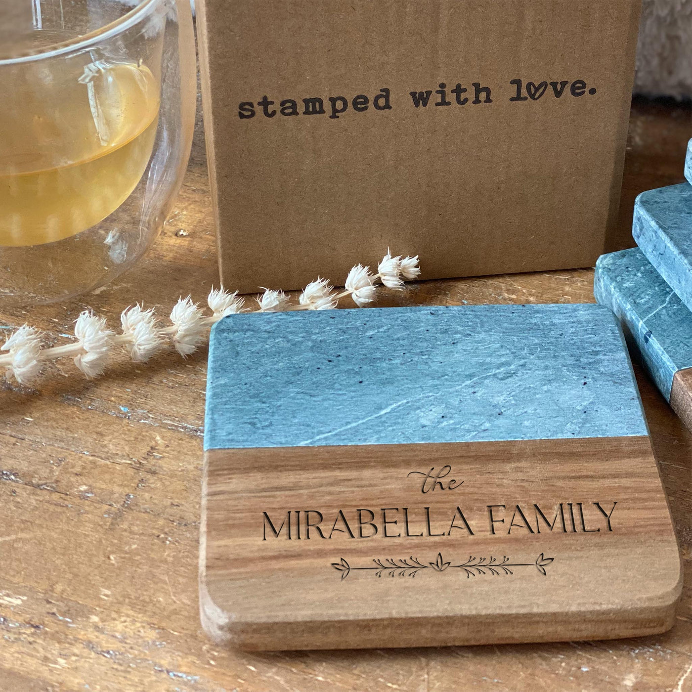 slate and wood coaster engraved with the text mirabella family