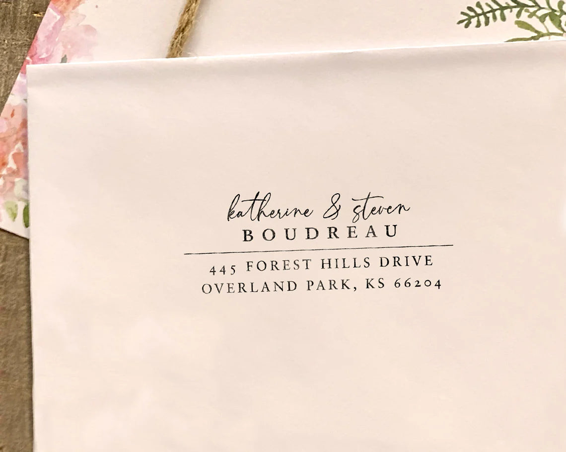 Elegant rectangular return address stamp with the names 'Katherine & Steven Boudreau' on an envelope