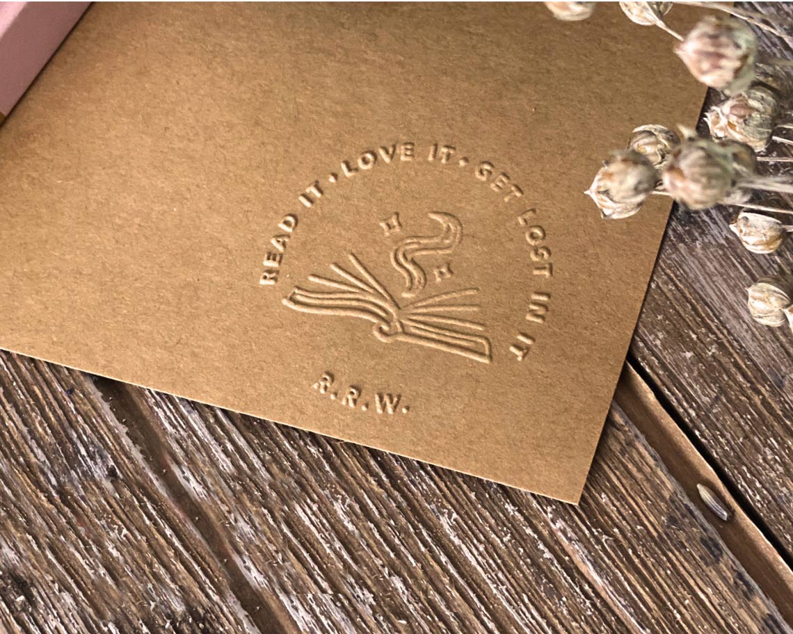 read it love it get lost in it book embossing on a brown stationery