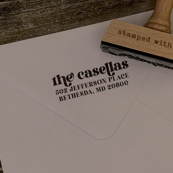 Custom return address rubber stamp with the imprint that says Casellas Family and their address on an envelope.