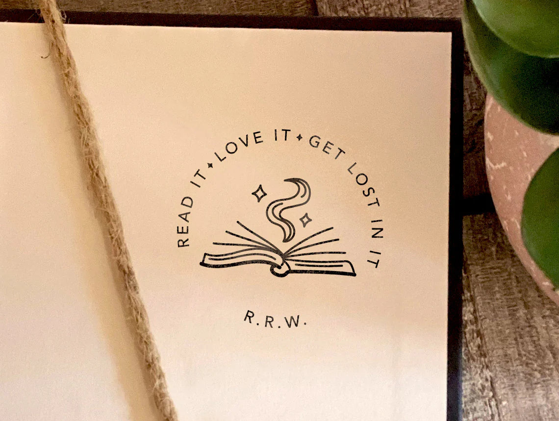 Custom book stamp with open book illustration and phrase read it love it get lost in it