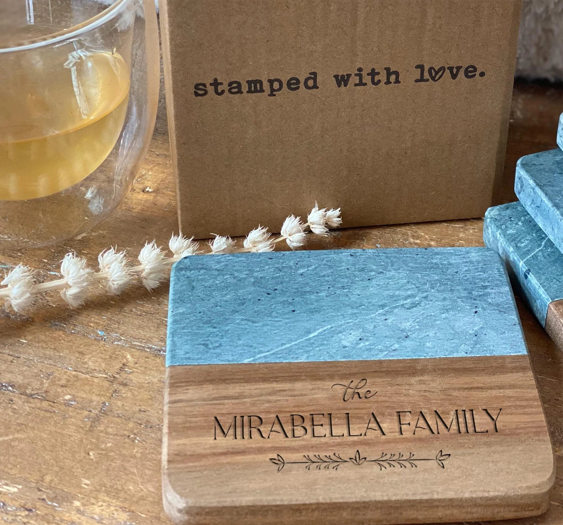 Custom square slate and wood coaster engraved with Mirabella Family name and decorative accents