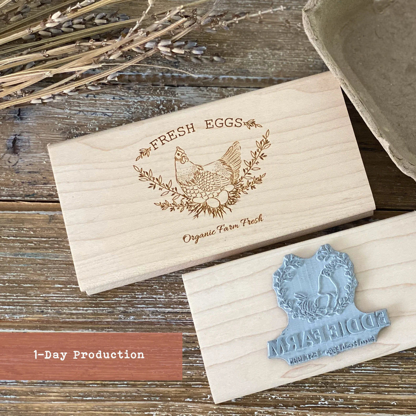 Engraved wooden egg carton stamp with chicken and wreath design reading "Fresh Eggs - Organic Farm Fresh"
