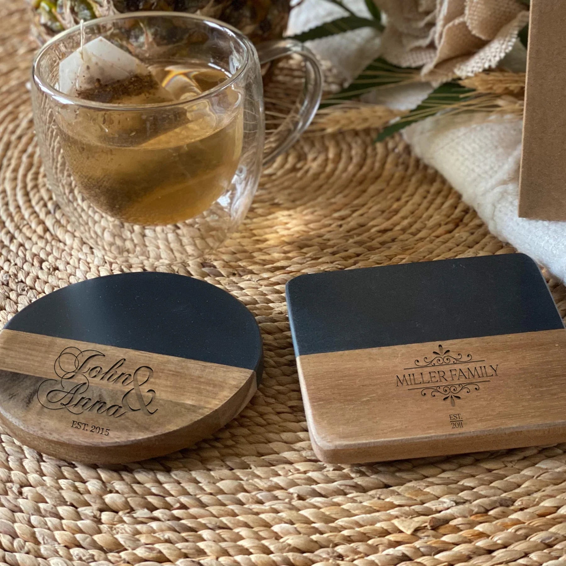 Set of personalized round and square black wood coasters engraved with John & Anna and Miller Family names