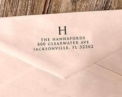 An elegant monogram return address stamp featuring a large initial in a classic typeface