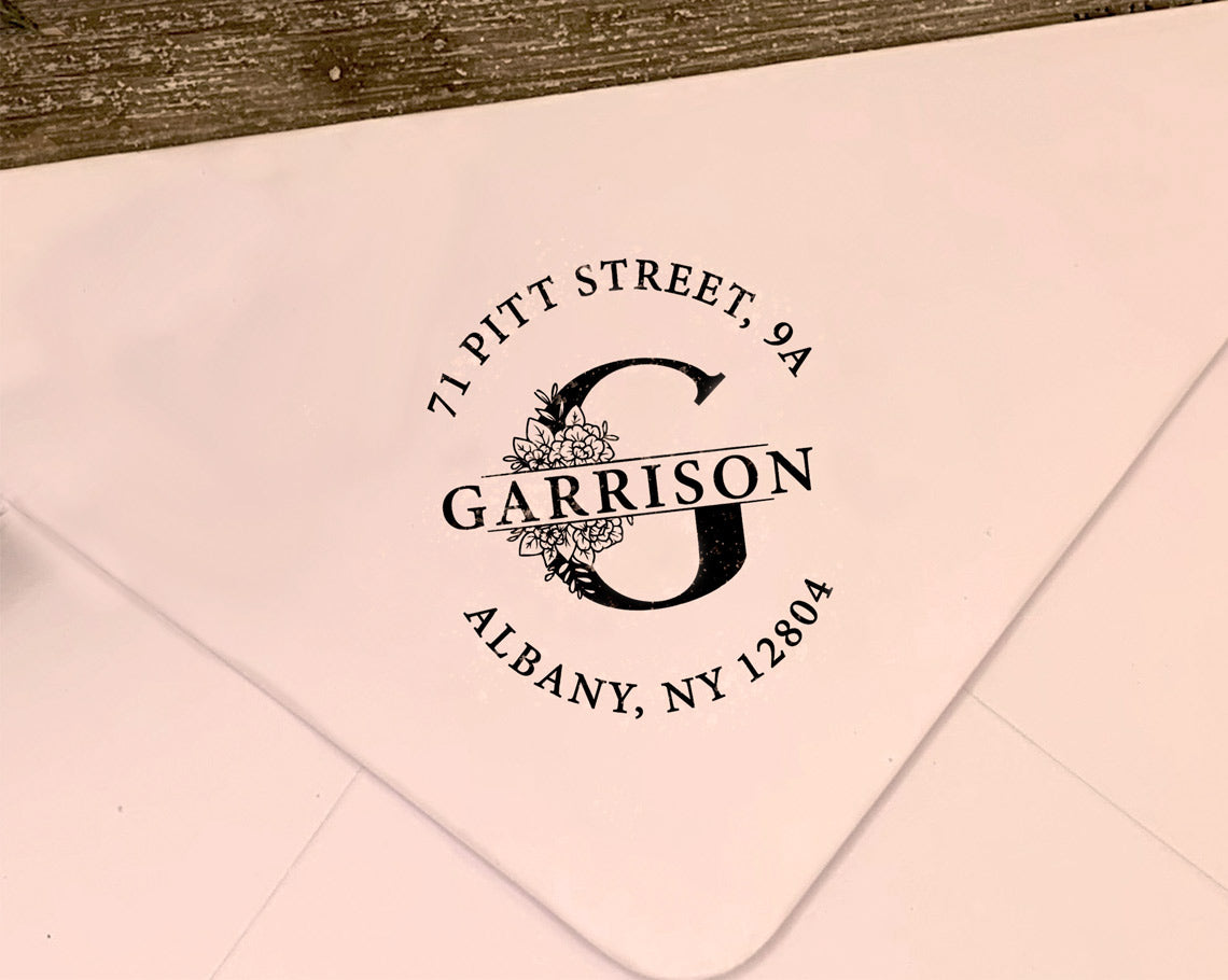A sophisticated return address logo stamp featuring a decorative initial G surrounded by floral accents with the Garrison name and return address in a refined font