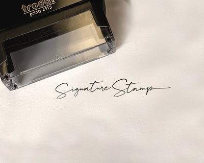 self inking signature stamp with example full signature imprinted on a white legal paper