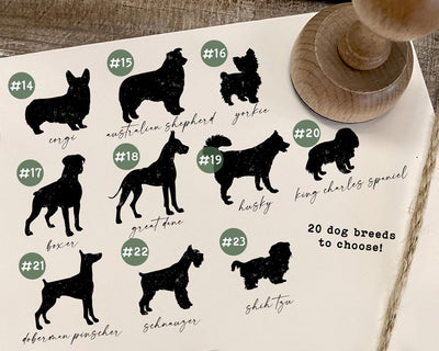 Craft paper with dog breed silhouettes and personalized address details for custom rubber stamp options each labeled with a unique number and breed name